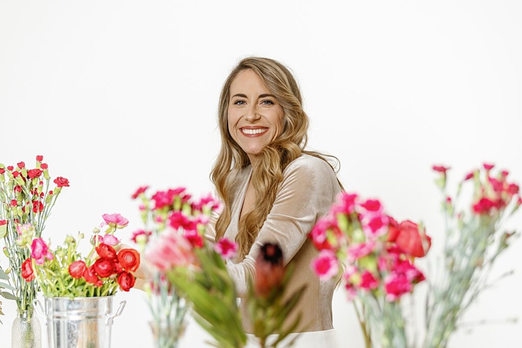 lifestyle branding photo of florist surrounded by flowers